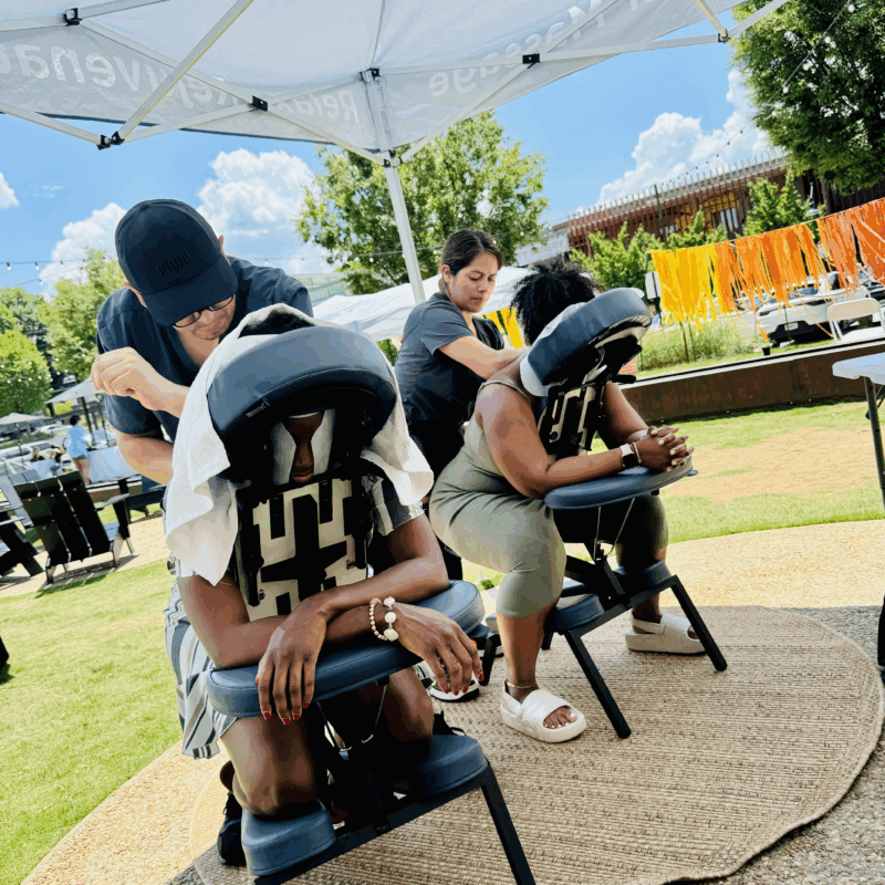 Customers getting a massage from the mobile massage service from Utopia Atlanta.